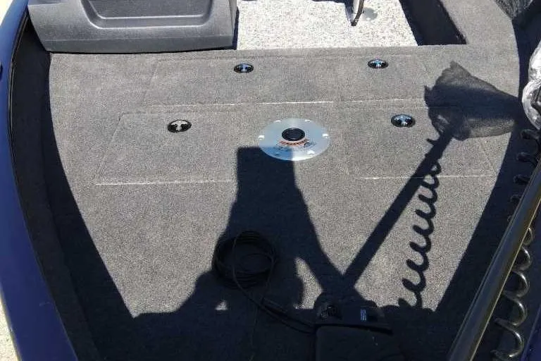 Slide: The Image of 2026 Tracker Pro Guide V-16 SC boat interior with carpeted deck and mounting points. - 3