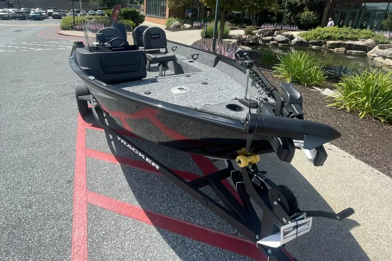 Slide: The Image of 2026 Tracker Pro Guide V-16 SC boat on display in outdoor setting. - 2