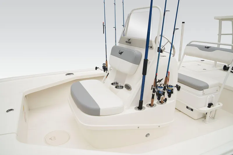 Slide: The Image of 2025 Mako 18 LTS boat with outboard motor, docked by a scenic lake. - 22