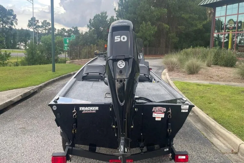 Slide: The Image of 2026 Tracker Bass Tracker Classic XL boat with Mercury 50 engine, parked outdoors. - 3