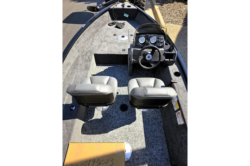 Slide: The Image of 2026 Tracker Super Guide V-16 SC boat interior with dual seats and steering console. - 3