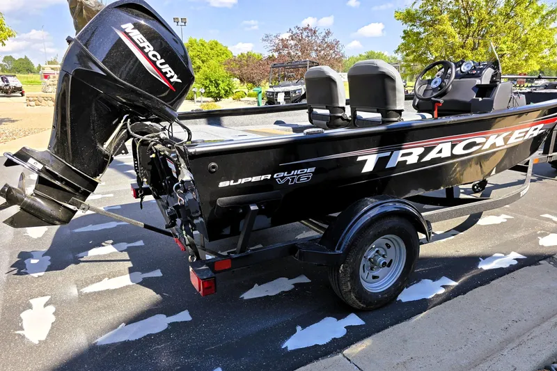 Slide: The Image of 2026 Tracker Super Guide V-16 SC boat with Mercury outboard motor on a trailer. - 4