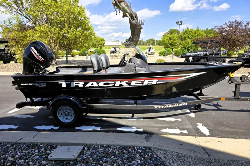 Slide: The Image of 2026 Tracker Super Guide V-16 SC boat on trailer, parked outdoors. - 5