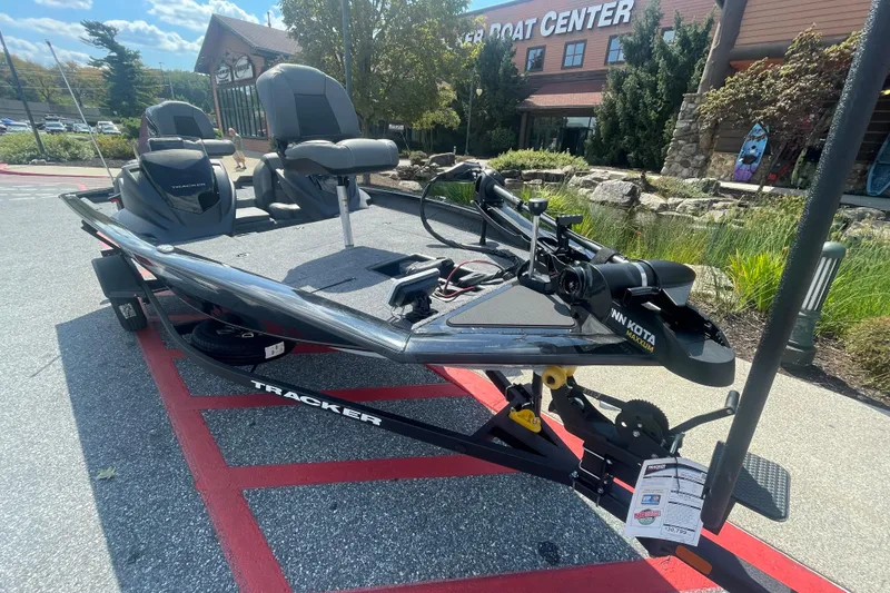 Slide: The Image of 2026 Tracker Pro Team 175 boat displayed outside a boat center on a sunny day. - 2