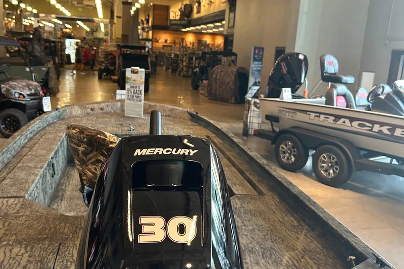 Slide: The Image of 2026 Tracker Grizzly 1654 T Sportsman boat with camo seat on deck. - 2