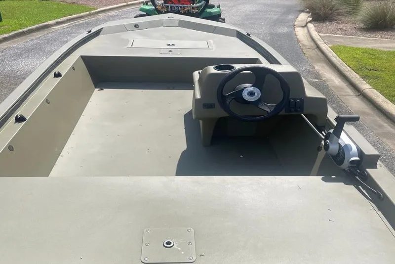 Slide: The Image of 2026 Tracker Grizzly 1648 SC boat interior with steering wheel and control panel. - 2