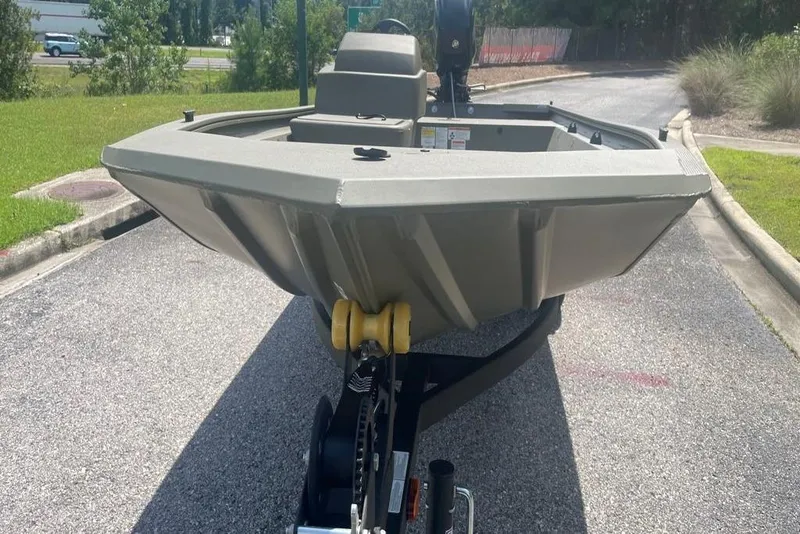 Slide: The Image of 2026 Tracker Grizzly 1648 SC boat on trailer, parked on a sunny road. - 4