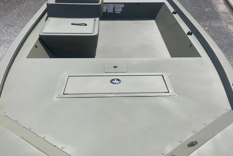 Slide: The Image of 2026 Tracker Grizzly 1648 SC boat interior with storage compartments, gray finish. - 5