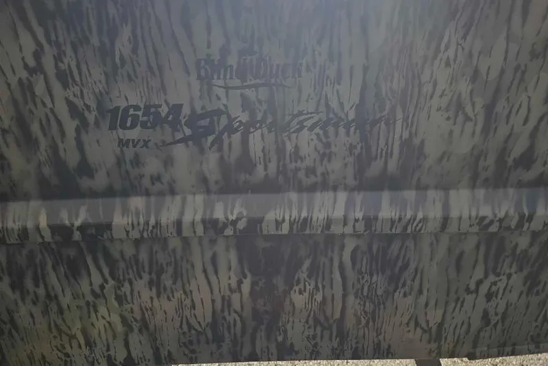 Slide: The Image of Camouflage-patterned Tracker Grizzly 1654 T Sportsman boat, model year 2026. - 2