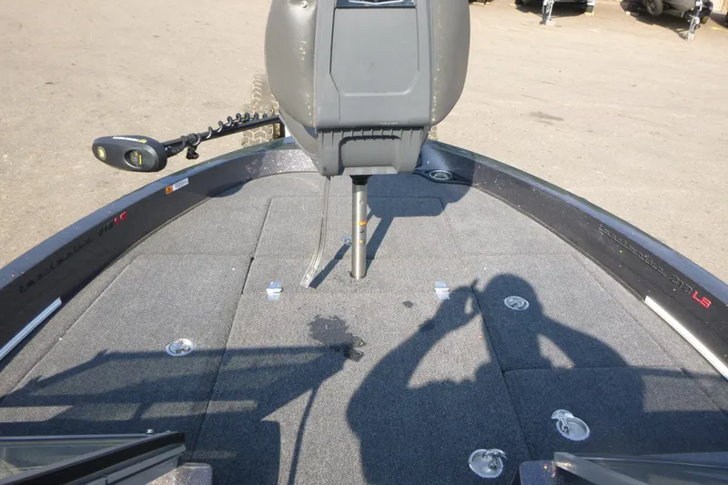 Slide: The Image of 2024 Ranger 212LS boat deck with trolling motor and carpeted surface. - 10