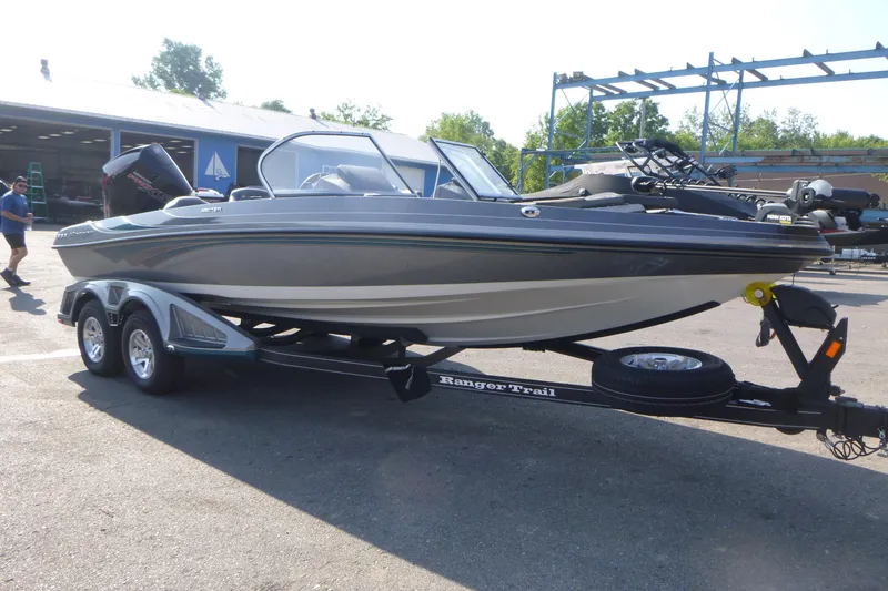 Slide: The Image of 2024 Ranger 212LS boat on trailer, parked outdoors, with clear sky background. - 3