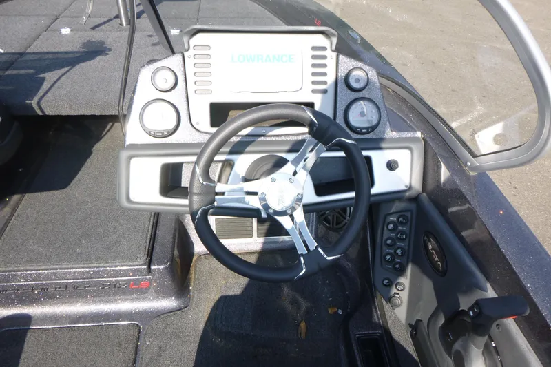 Slide: The Image of 2024 Ranger 212LS boat dashboard with steering wheel and control panel. - 8