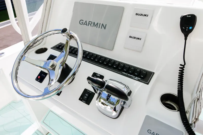 Slide: The Image of 2017 Albury Brothers center console boat dashboard with Garmin and Suzuki controls. - 13