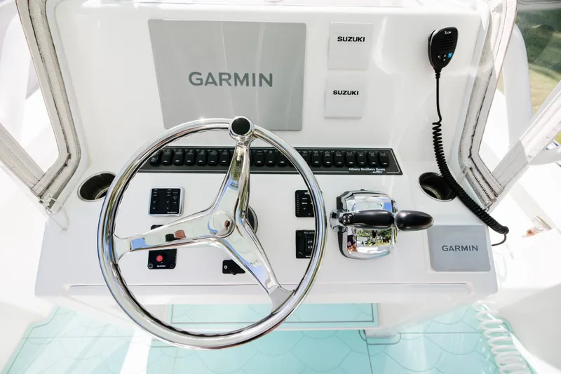 Slide: The Image of 2017 Albury Brothers center console boat dashboard with Garmin and Suzuki controls. - 14