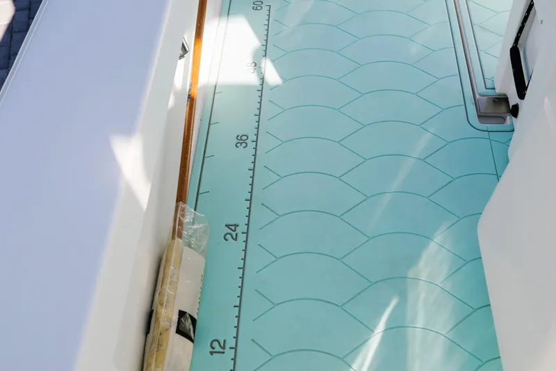 Slide: The Image of 2017 Albury Brothers center console boat with turquoise patterned deck and measuring scale. - 21