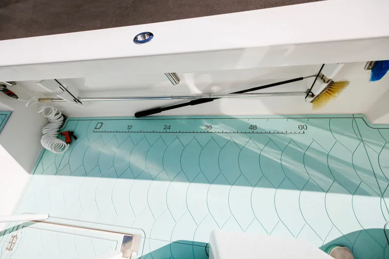 Slide: The Image of 2017 Albury Brothers center console boat deck with cleaning tools and measuring scale. - 22