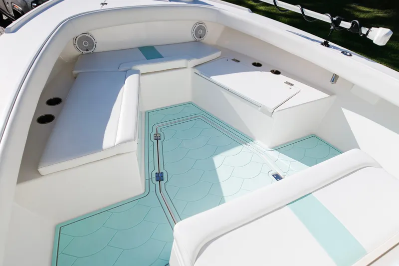 Slide: The Image of 2017 Albury Brothers center console boat interior with cushioned seating and teal flooring. - 23