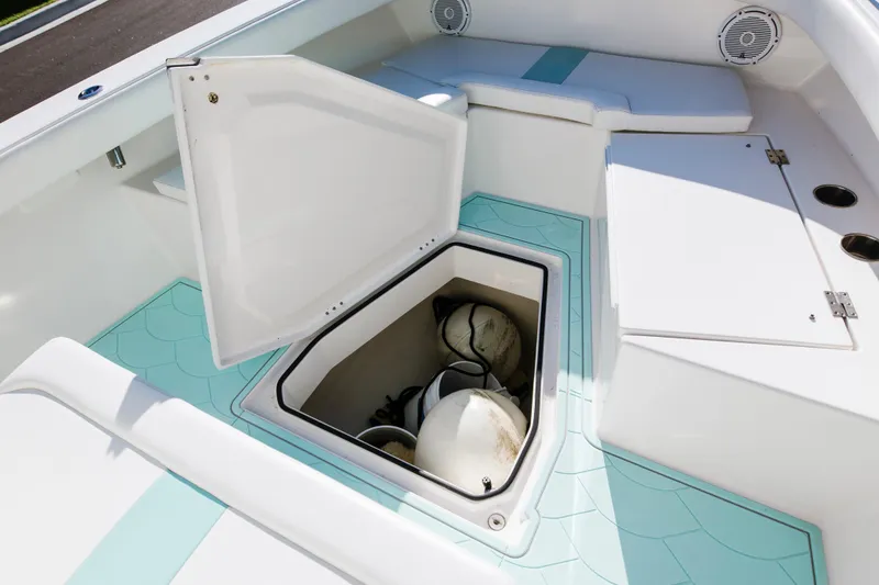 Slide: The Image of 2017 Albury Brothers center console boat with open storage compartment and teal flooring. - 27