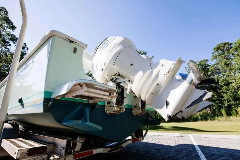 Slide: The Image of 2017 Albury Brothers center console boat on trailer, featuring powerful outboard motor. - 5
