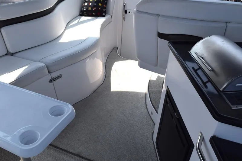 Slide: The Image of Interior of 2010 Rinker 310 Express Cruiser with seating and kitchenette. - 11