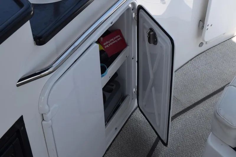 Slide: The Image of Open storage compartment on 2010 Rinker 310 Express Cruiser boat interior. - 16