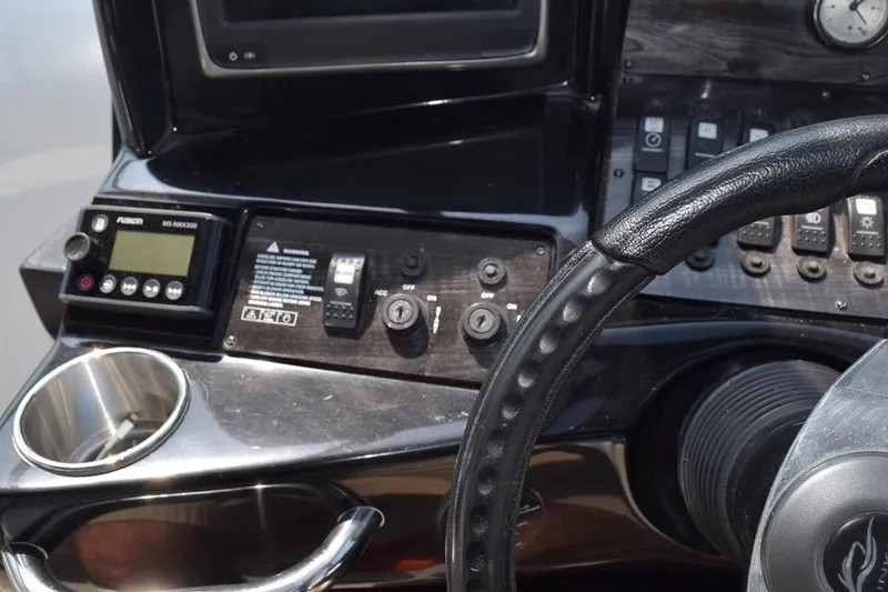 Slide: The Image of 2010 Rinker 310 Express Cruiser dashboard with steering wheel and control panel. - 22