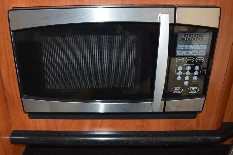 Slide: The Image of Built-in microwave in 2010 Rinker 310 Express Cruiser kitchen area. - 34
