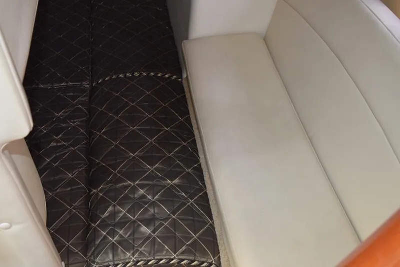 Slide: The Image of 2010 Rinker 310 Express Cruiser interior seating with quilted upholstery. - 39