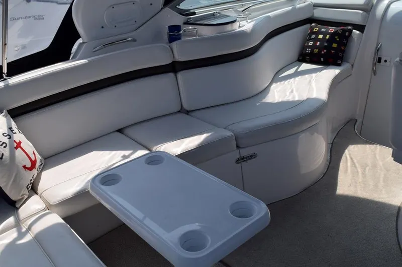 Slide: The Image of 2010 Rinker 310 Express Cruiser interior with white seating and table. - 7