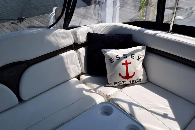 Slide: The Image of Luxurious seating on 2010 Rinker 310 Express Cruiser with nautical-themed pillow. - 9