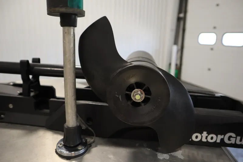 Slide: The Image of Close-up of a 1997 Tracker 18 Pro Team SC boat propeller in a garage. - 11