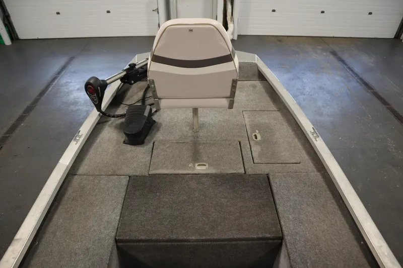 Slide: The Image of 1997 Tracker 18 Pro Team SC boat interior with seat and storage compartments. - 13