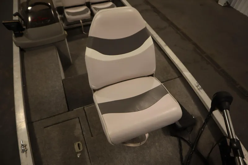 Slide: The Image of 1997 Tracker 18 Pro Team SC boat interior with gray and white seating. - 15