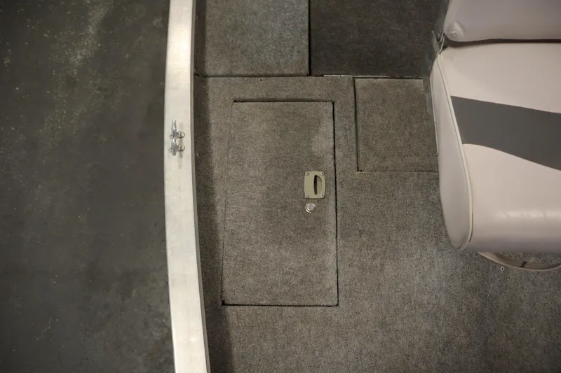 Slide: The Image of 1997 Tracker 18 Pro Team SC boat interior with carpeted floor and storage compartment. - 16