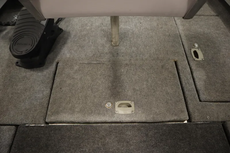 Slide: The Image of 1997 Tracker 18 Pro Team SC boat interior with carpeted flooring and storage compartments. - 18