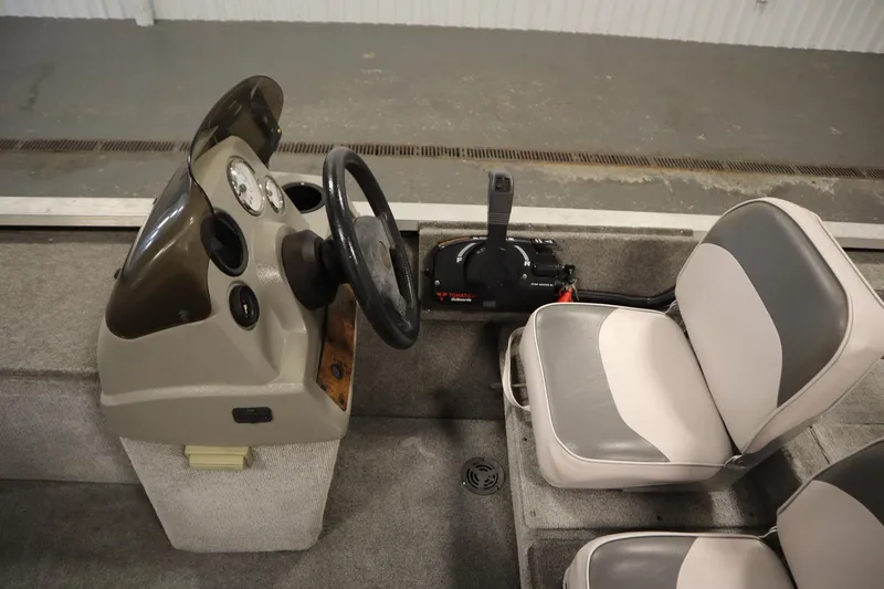 Slide: The Image of 1997 Tracker 18 Pro Team SC boat interior with steering wheel and seats. - 23