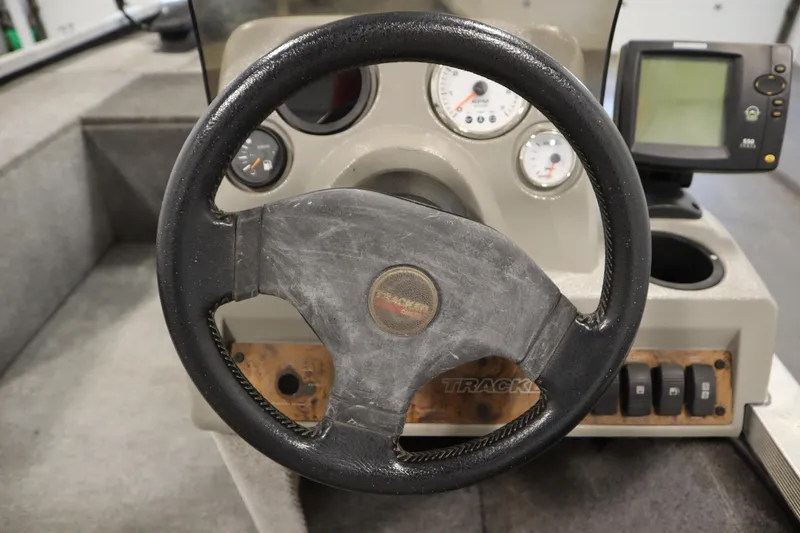 Slide: The Image of 1997 Tracker 18 Pro Team SC boat dashboard with steering wheel and gauges. - 25