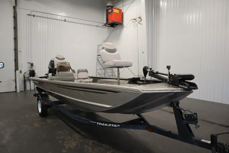 Slide: The Image of 1997 Tracker 18 Pro Team SC fishing boat on a trailer in a garage. - 3