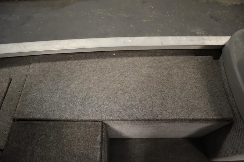 Slide: The Image of Interior view of a 1997 Tracker 18 Pro Team SC boat with gray carpeted flooring. - 31