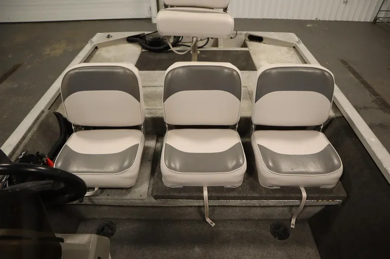 Slide: The Image of 1997 Tracker 18 Pro Team SC boat interior with three gray and white seats. - 33