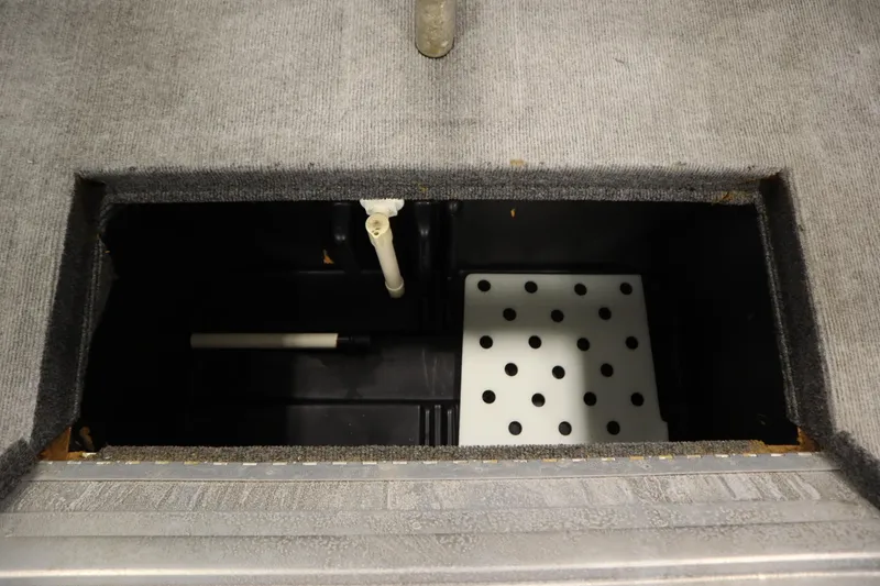 Slide: The Image of 1997 Tracker 18 Pro Team SC boat storage compartment with plumbing and drainage system. - 37