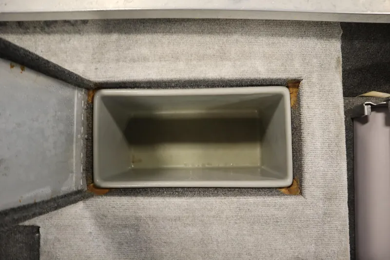 Slide: The Image of 1997 Tracker 18 Pro Team SC boat storage compartment, gray interior, top view. - 38