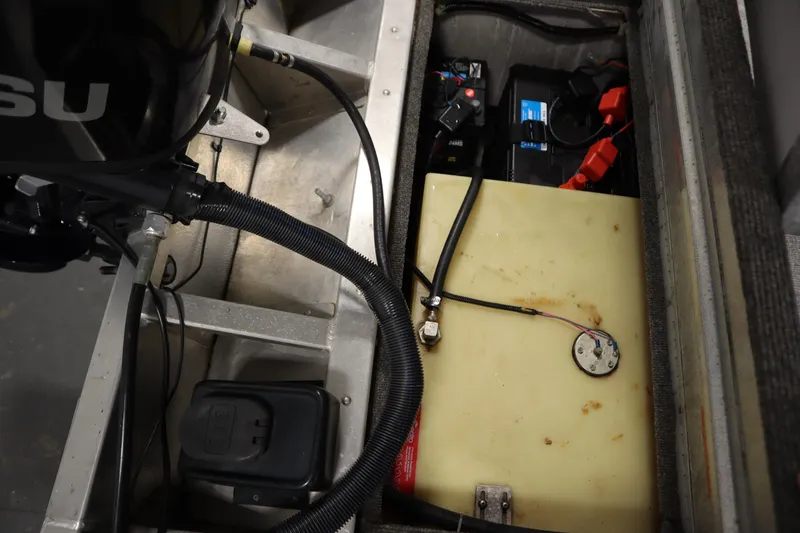 Slide: The Image of 1997 Tracker 18 Pro Team SC boat engine compartment with battery and fuel tank. - 41