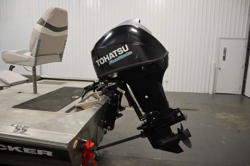 Slide: The Image of 1997 Tracker 18 Pro Team SC boat with Tohatsu four-stroke outboard motor in a garage. - 42