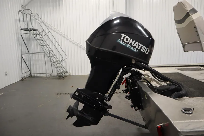 Slide: The Image of 1997 Tracker 18 Pro Team SC with Tohatsu FourStroke outboard motor in a garage. - 43