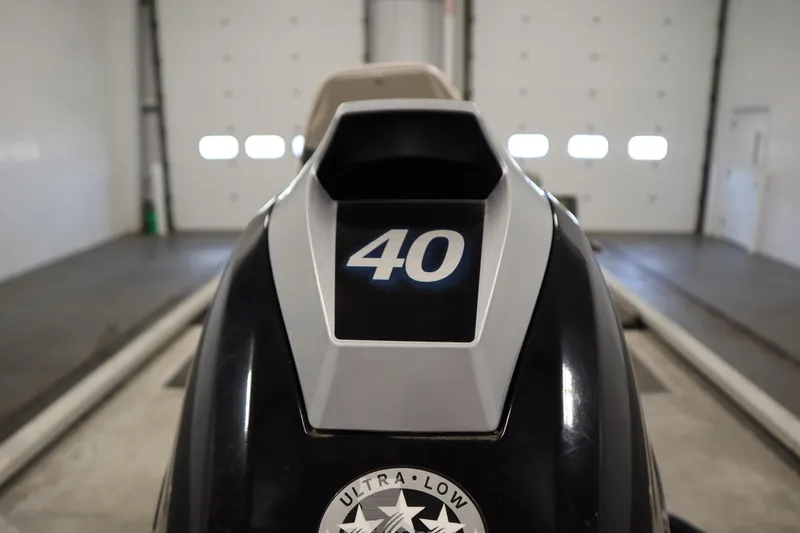 Slide: The Image of 1997 Tracker 18 Pro Team SC boat with "40" marking in a garage setting. - 44