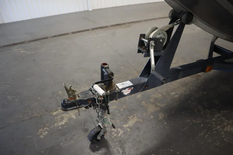 Slide: The Image of Trailer hitch of a 1997 Tracker 18 Pro Team SC boat on concrete floor. - 46