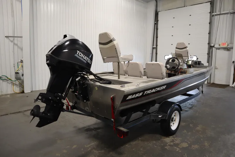 Slide: The Image of 1997 Tracker 18 Pro Team SC boat with Tohatsu outboard motor in a garage. - 5