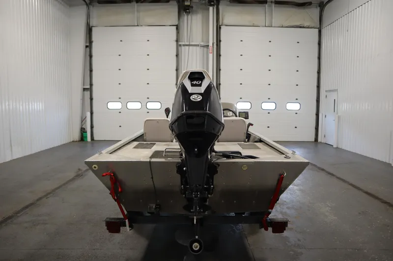 Slide: The Image of 1997 Tracker 18 Pro Team SC boat in a garage, rear view with motor. - 6