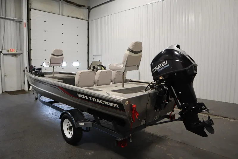 Slide: The Image of 1997 Tracker 18 Pro Team SC boat with Tohatsu outboard motor in a garage. - 7